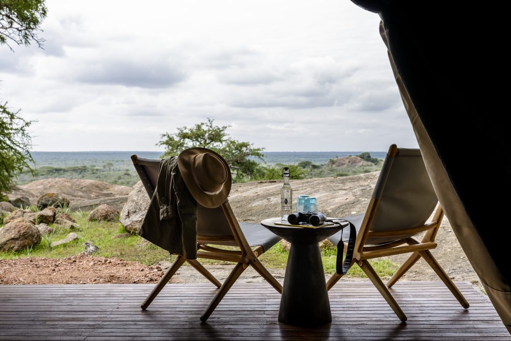 Tanzania, Serengeti National Park, Sanctuary Kichakani Serengeti Camp Sundowners with scenic view at luxury accommodation in Tanzania