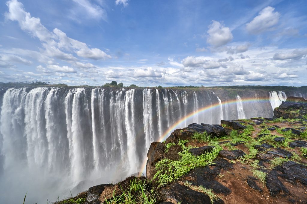 The,Panoramic,View,To,The,Majestic,Victoria,Falls,Waterfall,On Victoria falls with rainbow in Zambia on luxury, private tour.