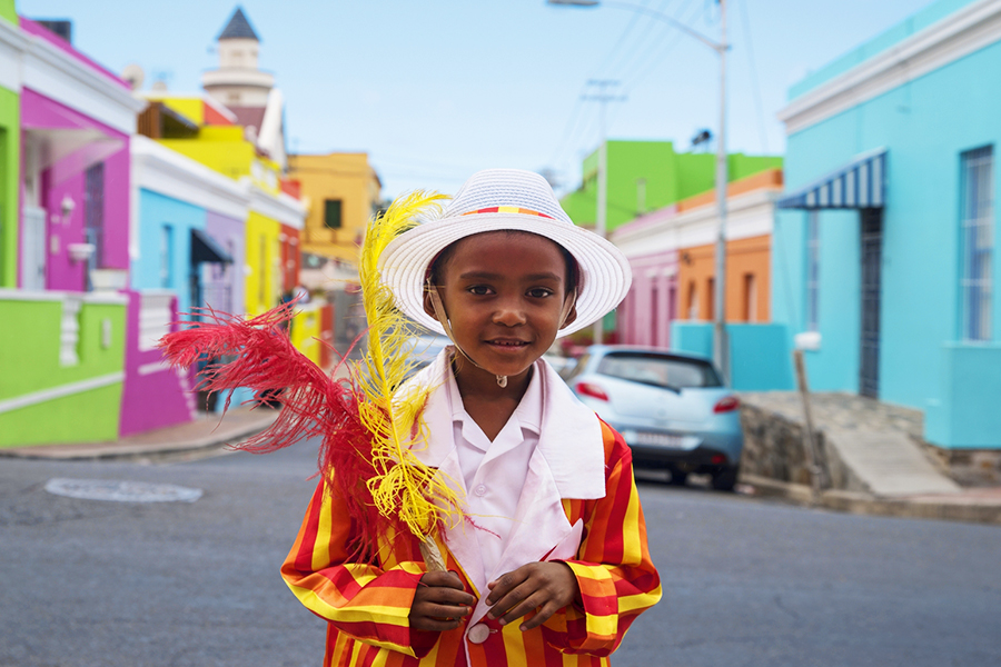Local child walking in streets with a private tour group in Cape Town