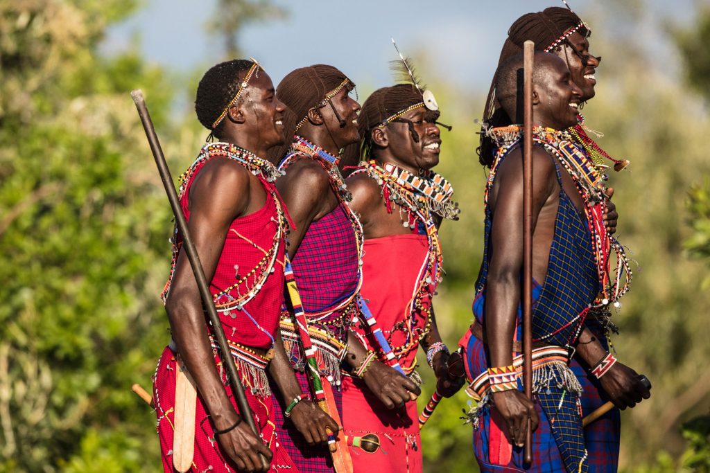 warriors-in-action Cultural dress and dancing, part of the sightseeing excursion while on a luxury safari in East Africa.