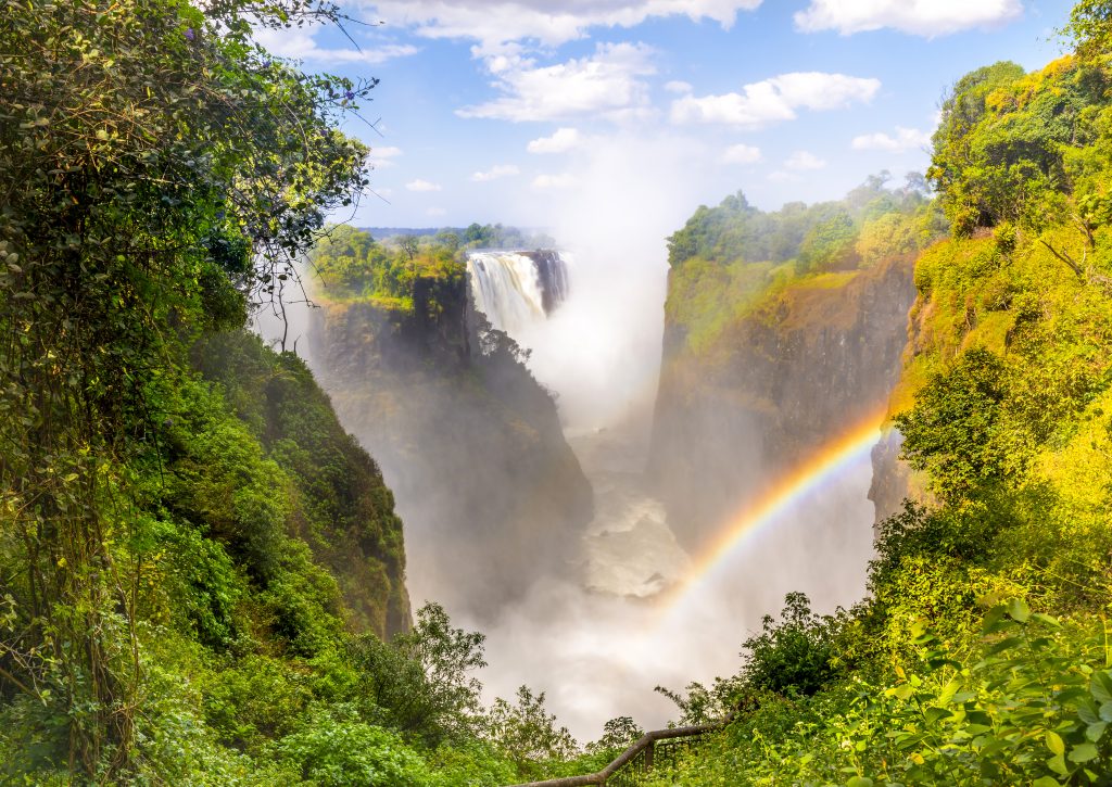 Victoria,Falls,Waterfall,In,Africa,,Between,Zambia,And,Zimbabwe,,One Sightseeing Victoria Falls in Zambia with rainbow while on an exclusive, luxury safari with Premier Africa