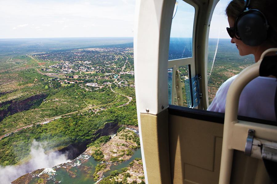 Sightseeing Victoria Falls in Zambia from a private helicopter ride while on luxury safari.