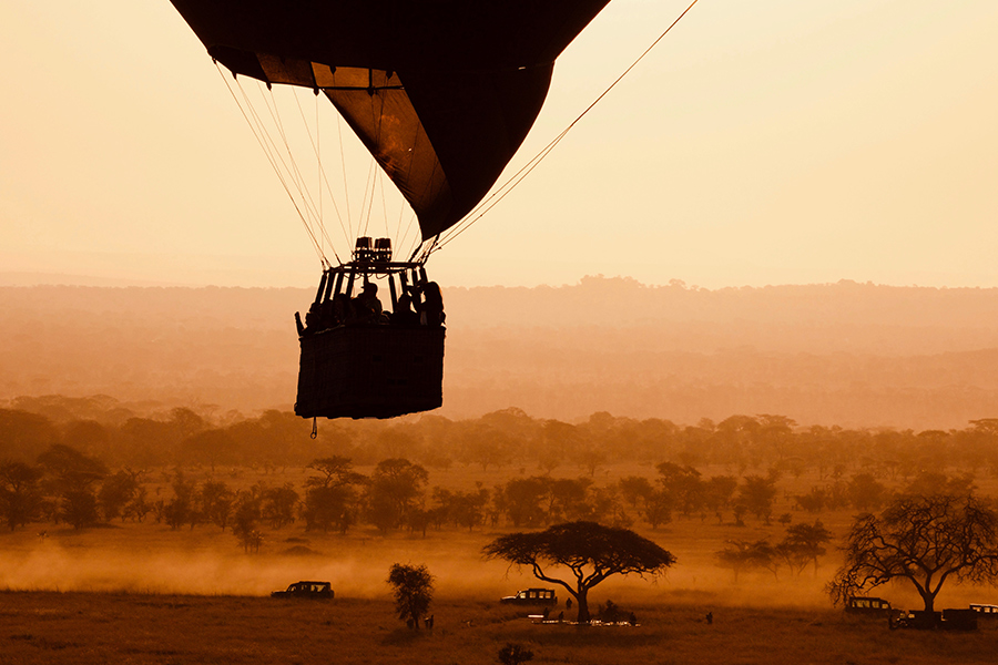 Dawn hot air balloon ride at grumeti reserve with view of game drive and trees